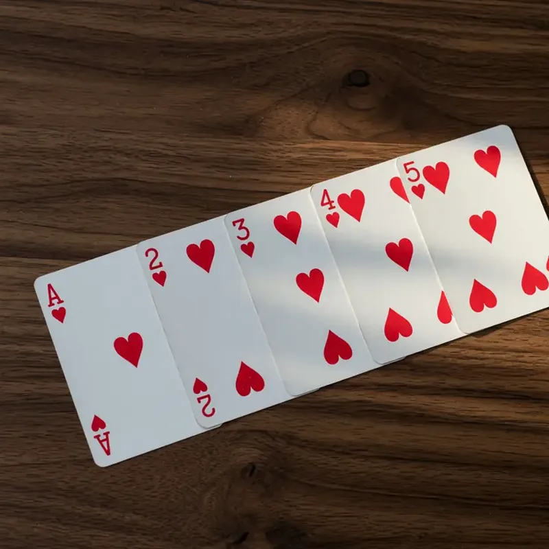 A pure rummy sequence laid in a straight row on dark walnut